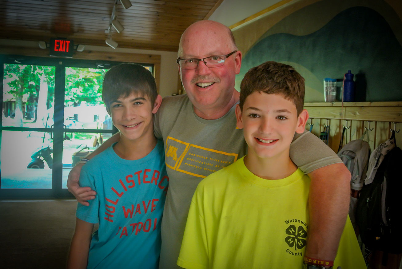 Coach Kill poses with two boy at Camp OZ.